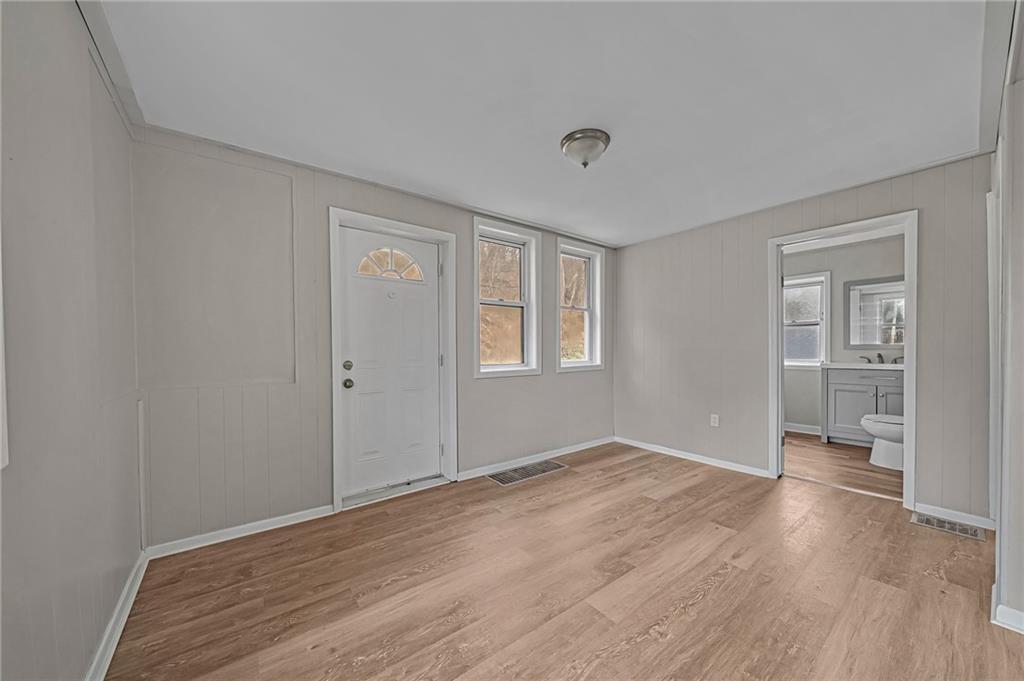 980 Crucible Road Rices Landing, PA 15357 - Photo 20 of 24 a view of an empty room with wooden floor and a window