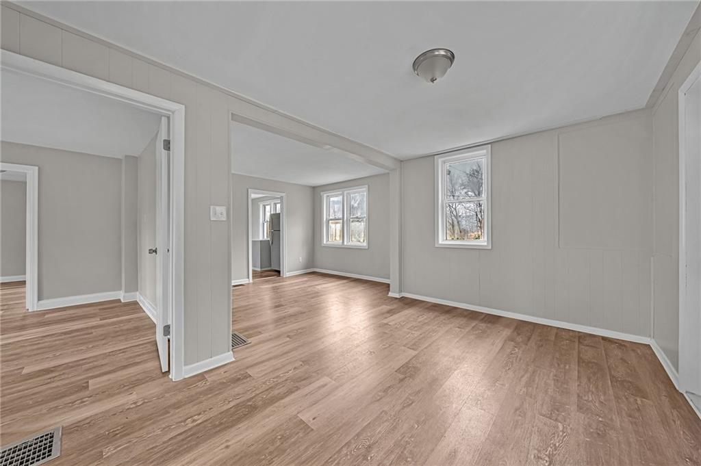 980 Crucible Road Rices Landing, PA 15357 - Photo 5 of 24 a view of an empty room with wooden floor and a window