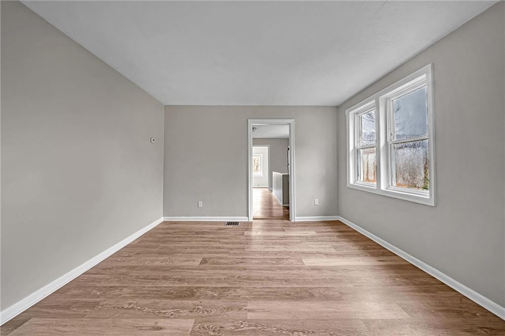 980 Crucible Road Rices Landing, PA 15357 - Photo 9 of 24 a view of an empty room with window and wooden floor