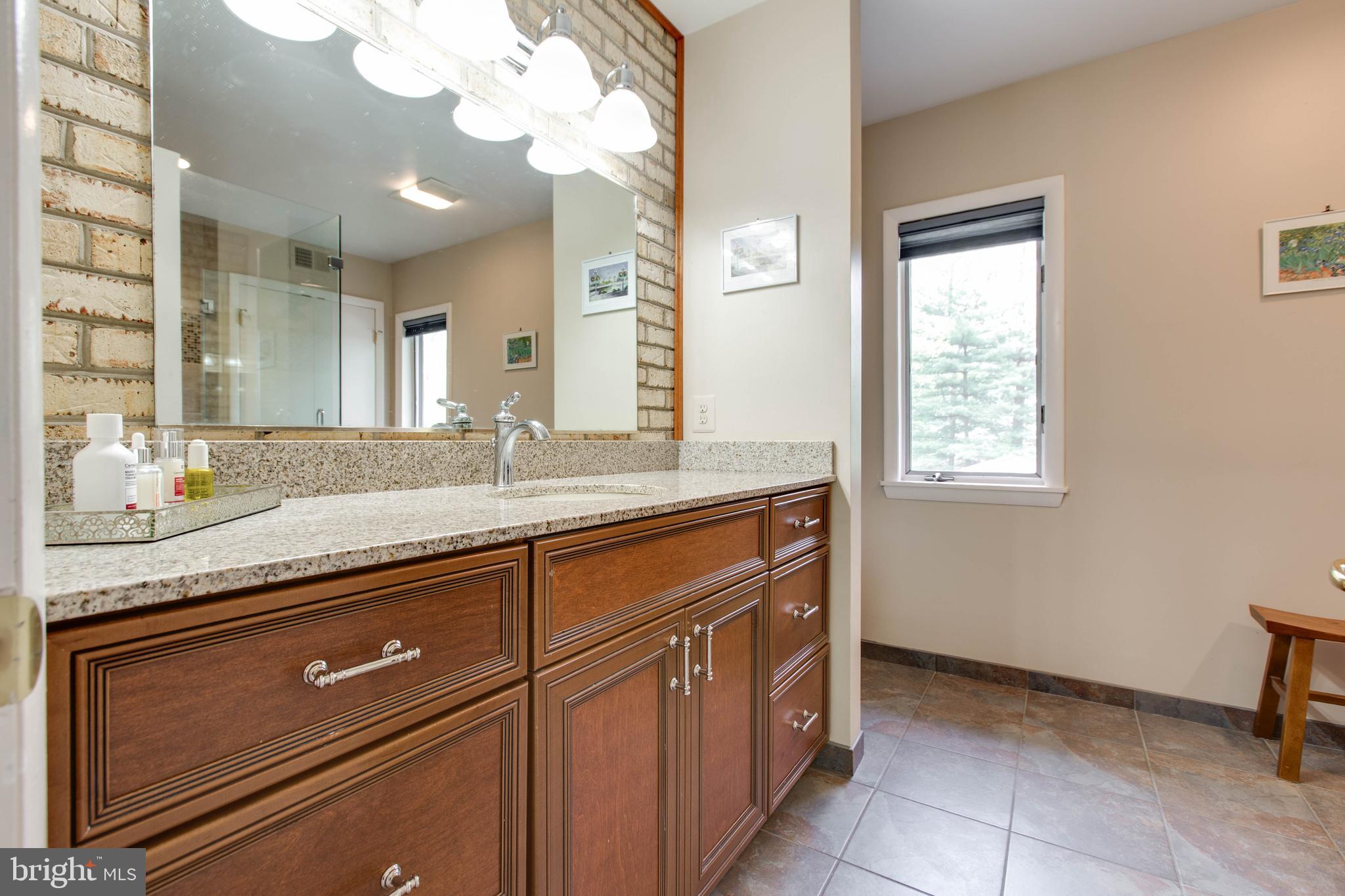 5519 Woodbine Road Sykesville, MD 21784 - Photo 43 of 69 a bathroom with a granite countertop sink a mirror and a vanity