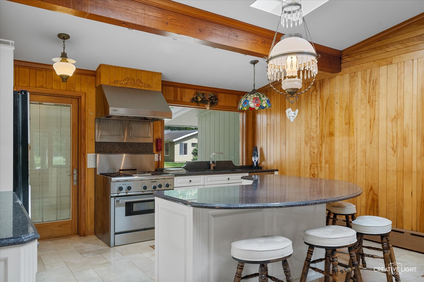 16323 Griswold Springs Road Plano, IL 60545 - Photo 13 of 55 a kitchen with stainless steel appliances a table chairs and chandelier