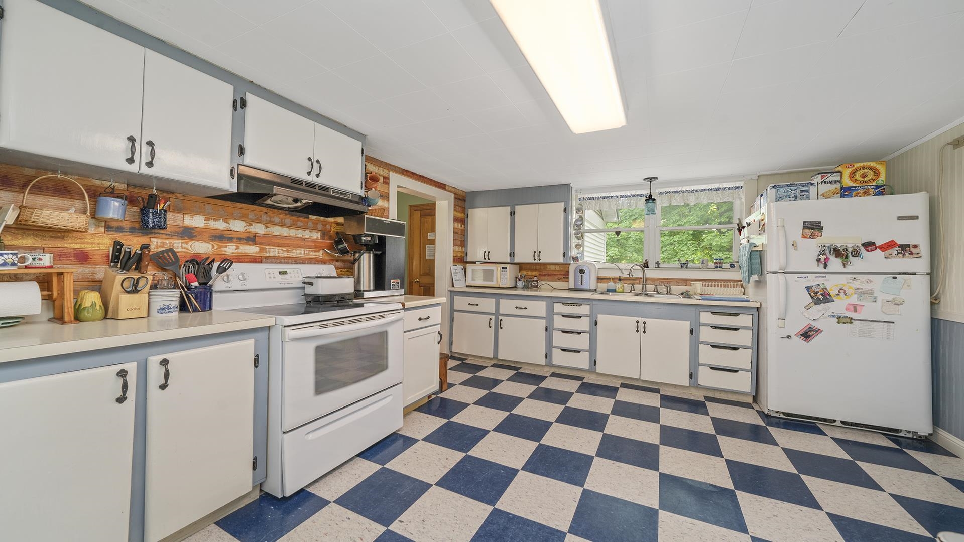 13524 White School Road Roscoe, IL 61073 - Photo 11 of 23 a kitchen with white cabinets a white counter top and a stove top oven