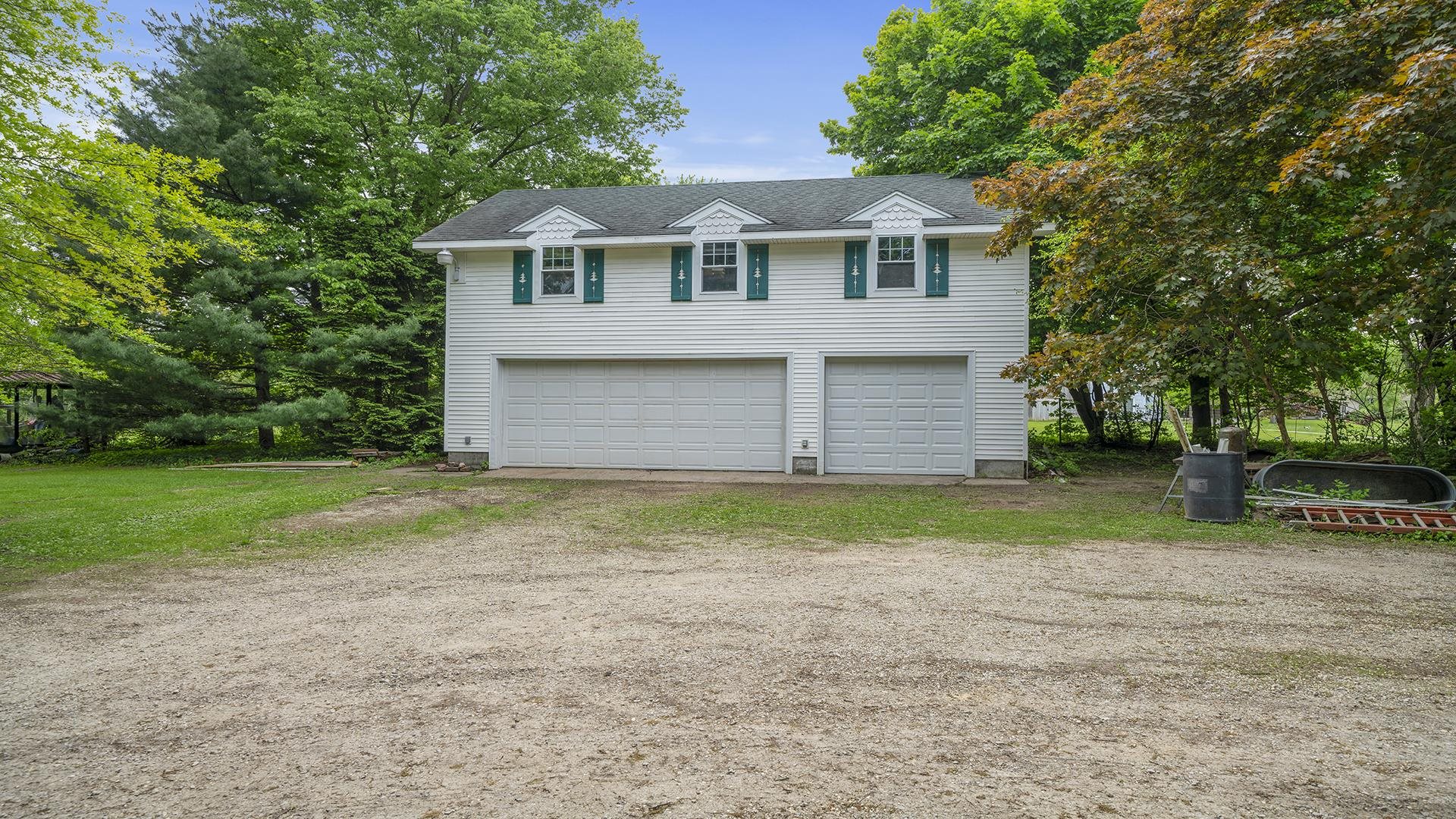 13524 White School Road Roscoe, IL 61073 - Photo 2 of 23 a front view of a house with a yard and trees