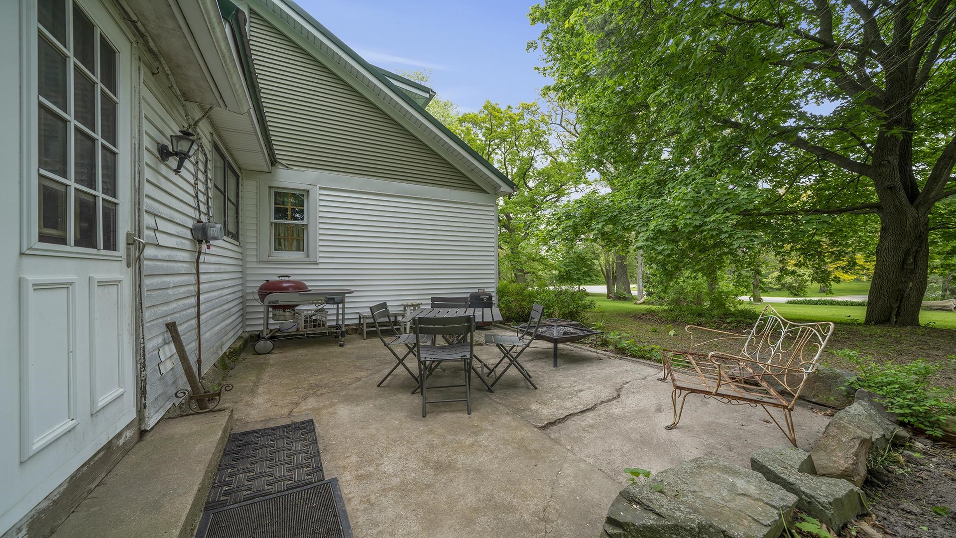 13524 White School Road Roscoe, IL 61073 - Photo 21 of 23 a backyard of a house with table and chairs
