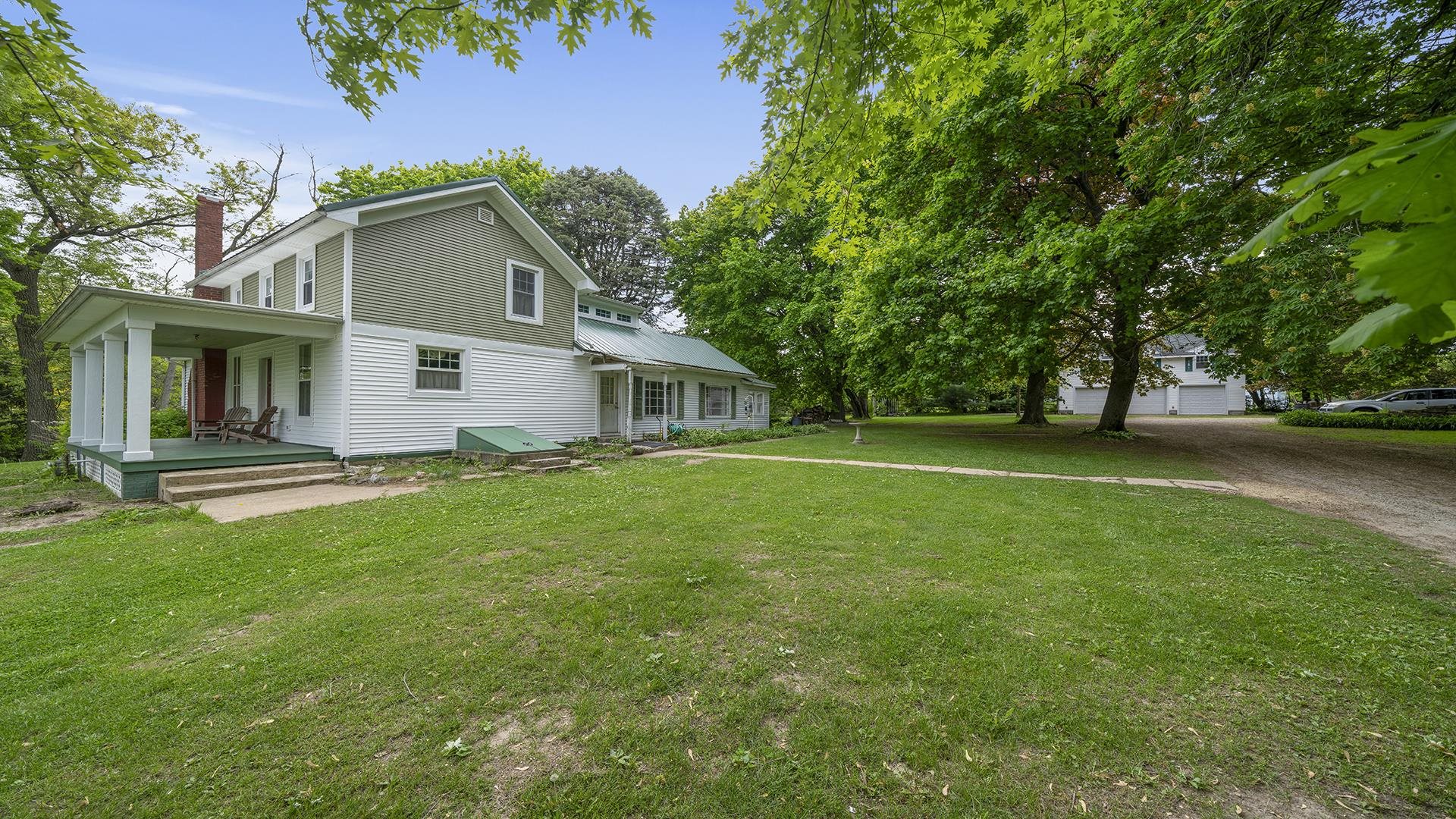 13524 White School Road Roscoe, IL 61073 - Photo 3 of 23 a front view of a house with a garden
