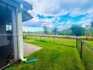 a view of a park with large trees