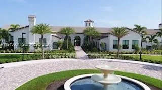a front view of a house with garden and patio