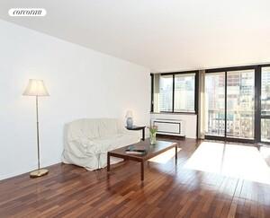 330 East 75th Street, Unit 9D Manhattan, NY 10021 - Photo 2 of 7 a living room with furniture and a large window