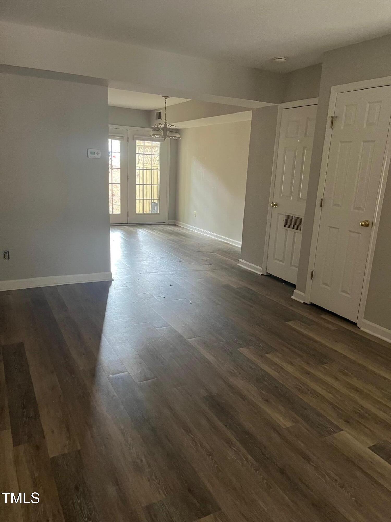 4822 Blue Bird Court, Unit C Raleigh, NC 27606 - Photo 2 of 3 a view of a room with wooden floor and window
