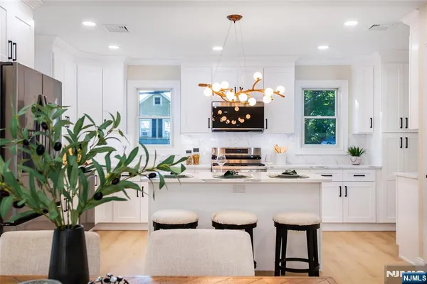 a kitchen with sink a microwave and cabinets