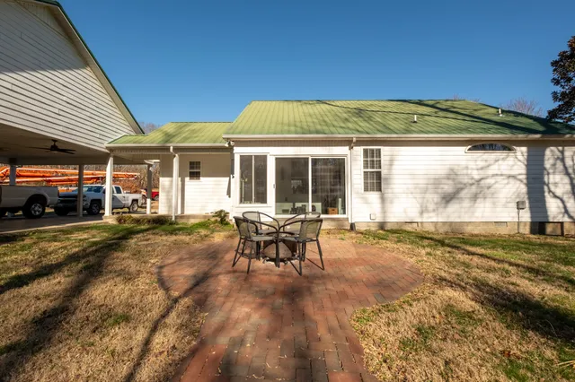 a view of a house with backyard and sitting area