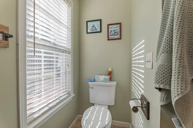a bathroom with a toilet and a shower curtain