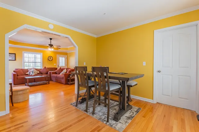 a living room with dining room and wooden floor