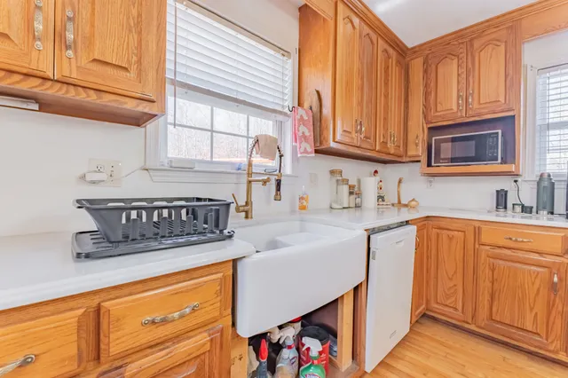 a kitchen with stainless steel appliances granite countertop a sink a stove and cabinets