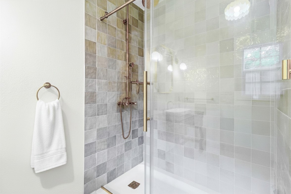 600 Wilderness Road Point Blank, TX 77364 - Photo 11 of 28 Spa-inspired walk-in shower featuring floor-to-ceiling tile and glass enclosure. *digitally enhanced