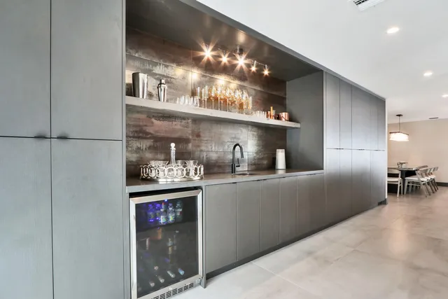 a kitchen with a dining table and chairs with wooden floor