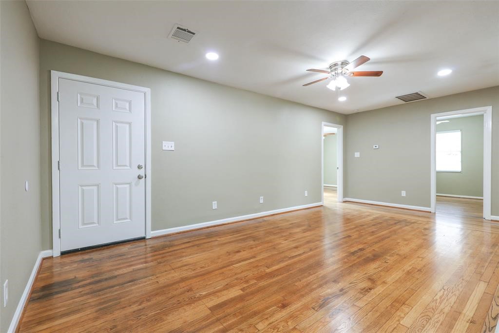 4139 Lumberdale Road Houston, TX 77092 - Photo 12 of 31 an empty room with wooden floor and fan
