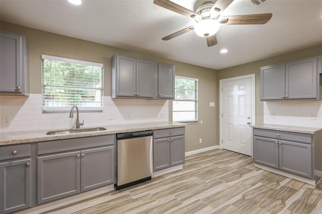 4139 Lumberdale Road Houston, TX 77092 - Photo 15 of 31 a kitchen with a sink stove and cabinets