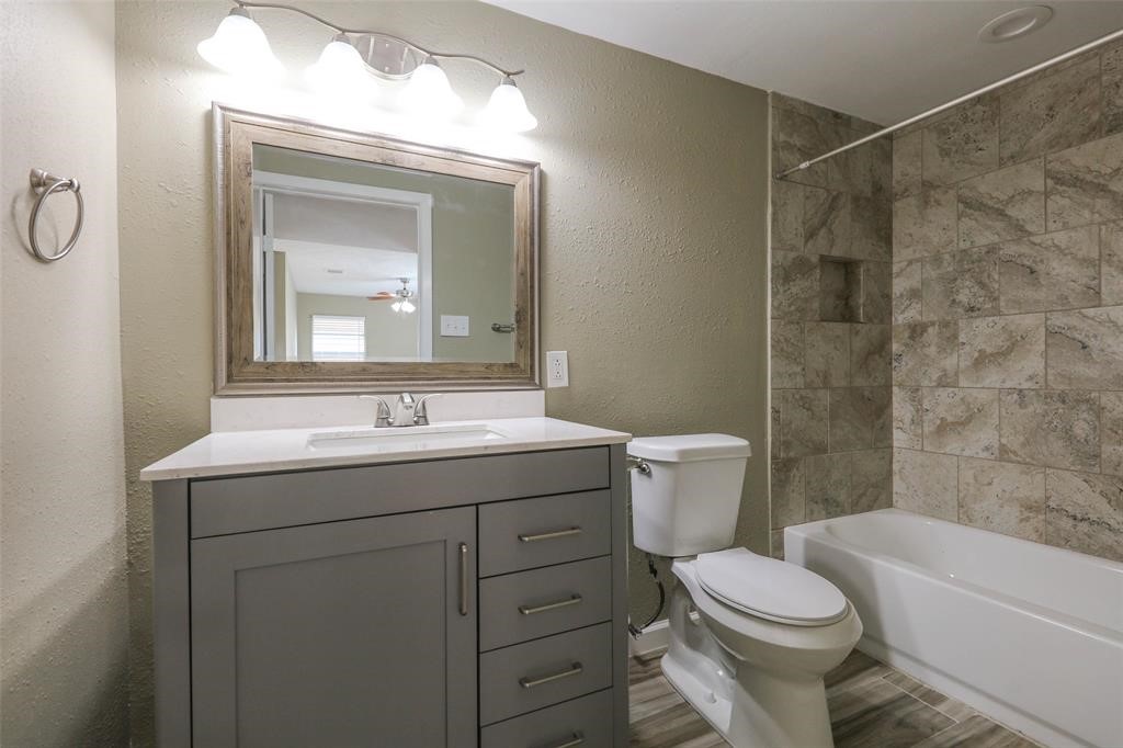 4139 Lumberdale Road Houston, TX 77092 - Photo 20 of 31 a bathroom with a toilet sink vanity tub and mirror