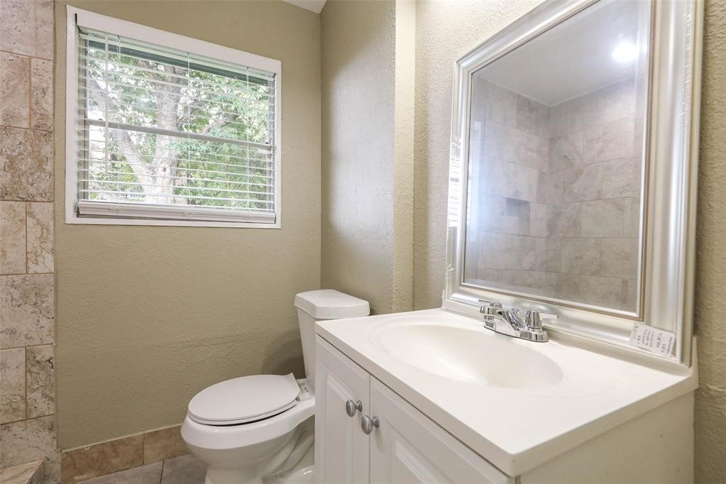 4139 Lumberdale Road Houston, TX 77092 - Photo 23 of 31 a bathroom with a sink toilet and a mirror