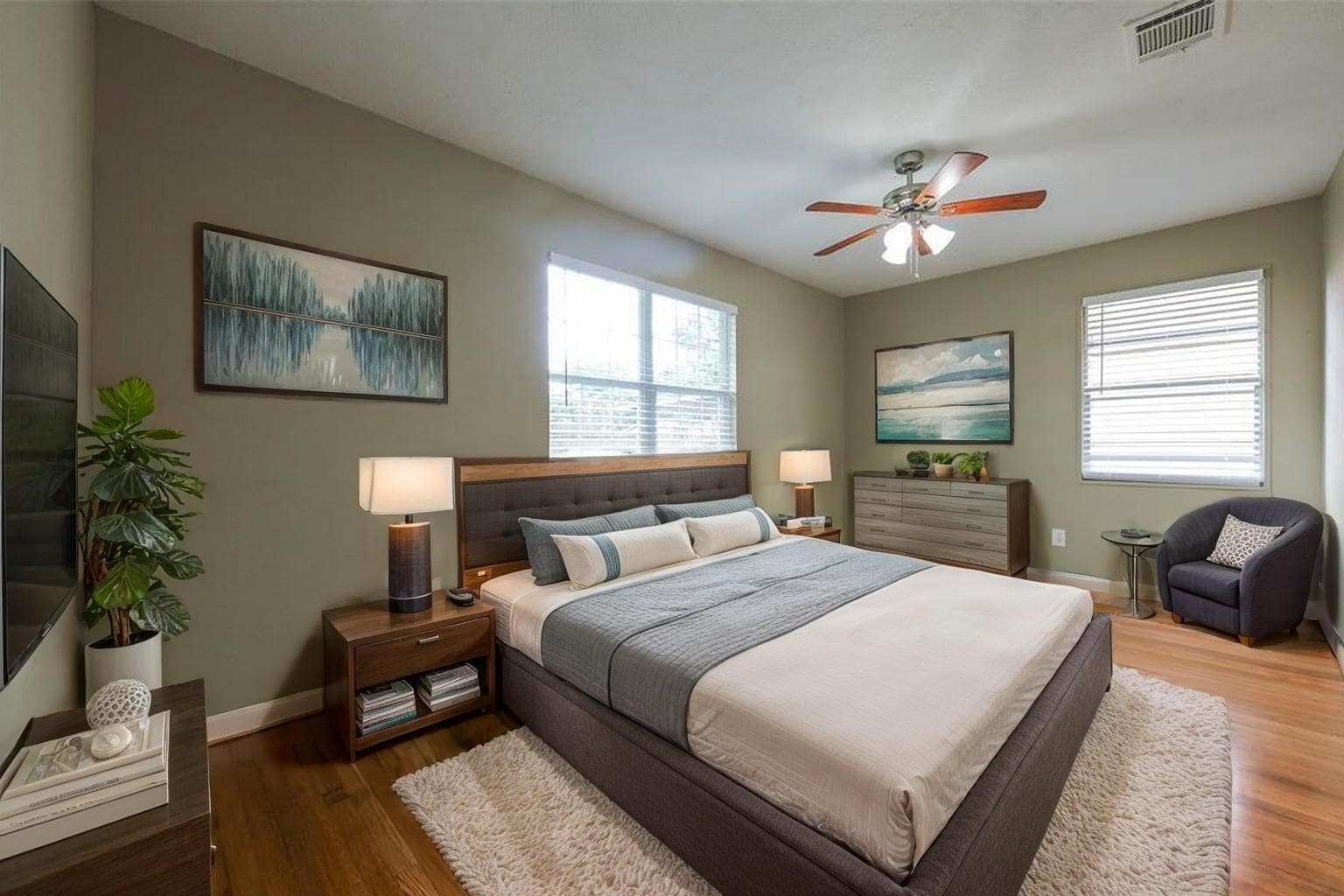 4139 Lumberdale Road Houston, TX 77092 - Photo 31 of 31 a spacious bedroom with a bed a couch and potted plant on the dresser