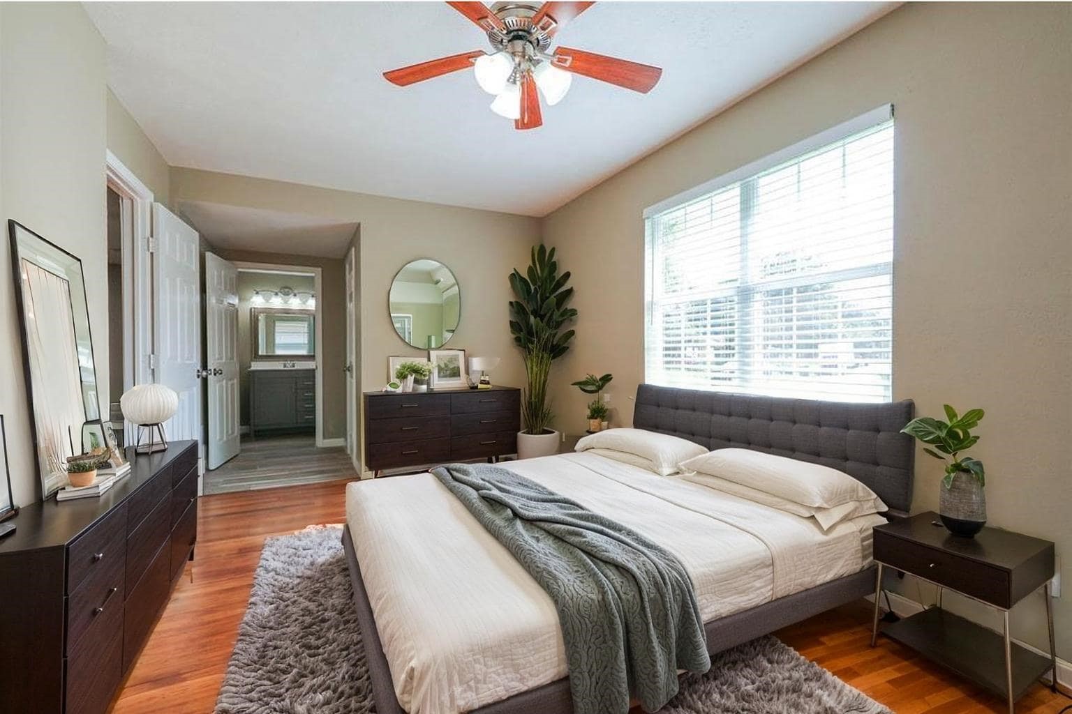 4139 Lumberdale Road Houston, TX 77092 - Photo 4 of 31 a bedroom with a bed a chandelier and a window