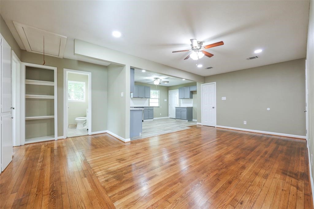 4139 Lumberdale Road Houston, TX 77092 - Photo 9 of 31 a view of an empty room with wooden floor and a ceiling fan