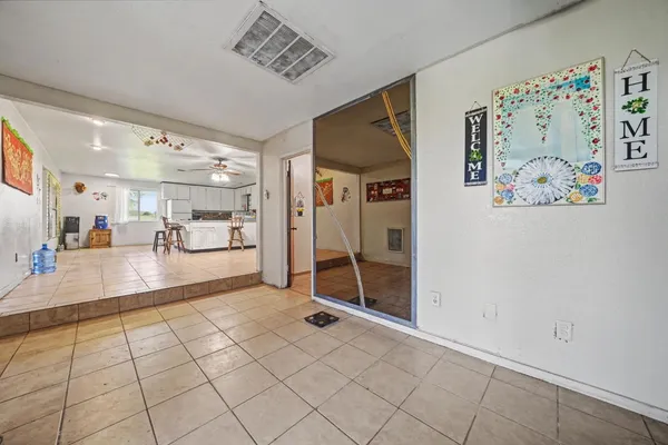 a living room with furniture and kitchen view