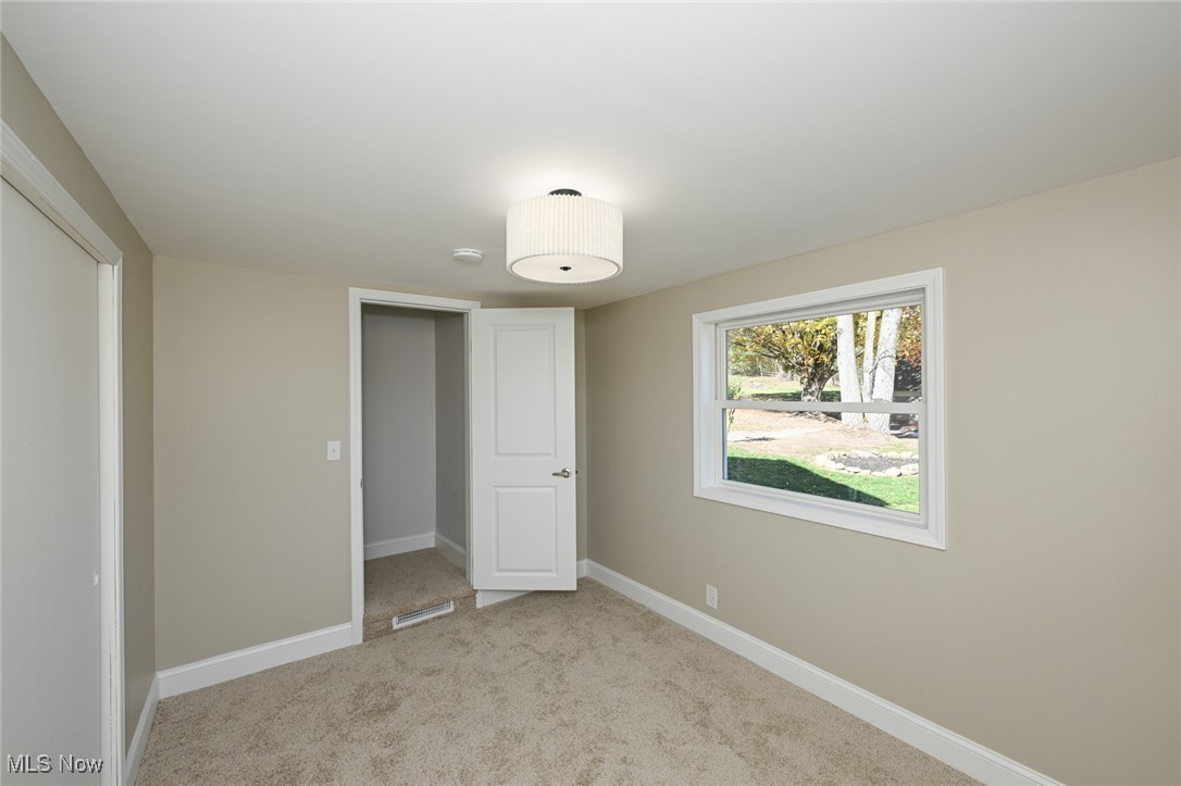 14328 Calaboone Road Doylestown, OH 44230 - Photo 23 of 45 Unfurnished bedroom featuring light colored carpet and a closet