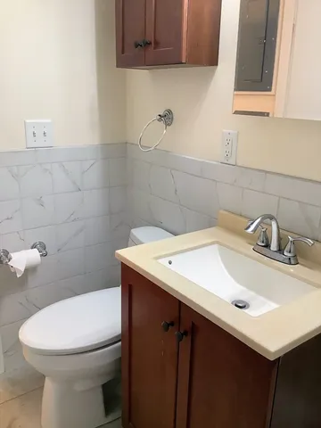 a bathroom with a sink a toilet and mirror