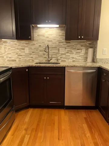 a kitchen with stainless steel appliances granite countertop a sink and a granite counter tops