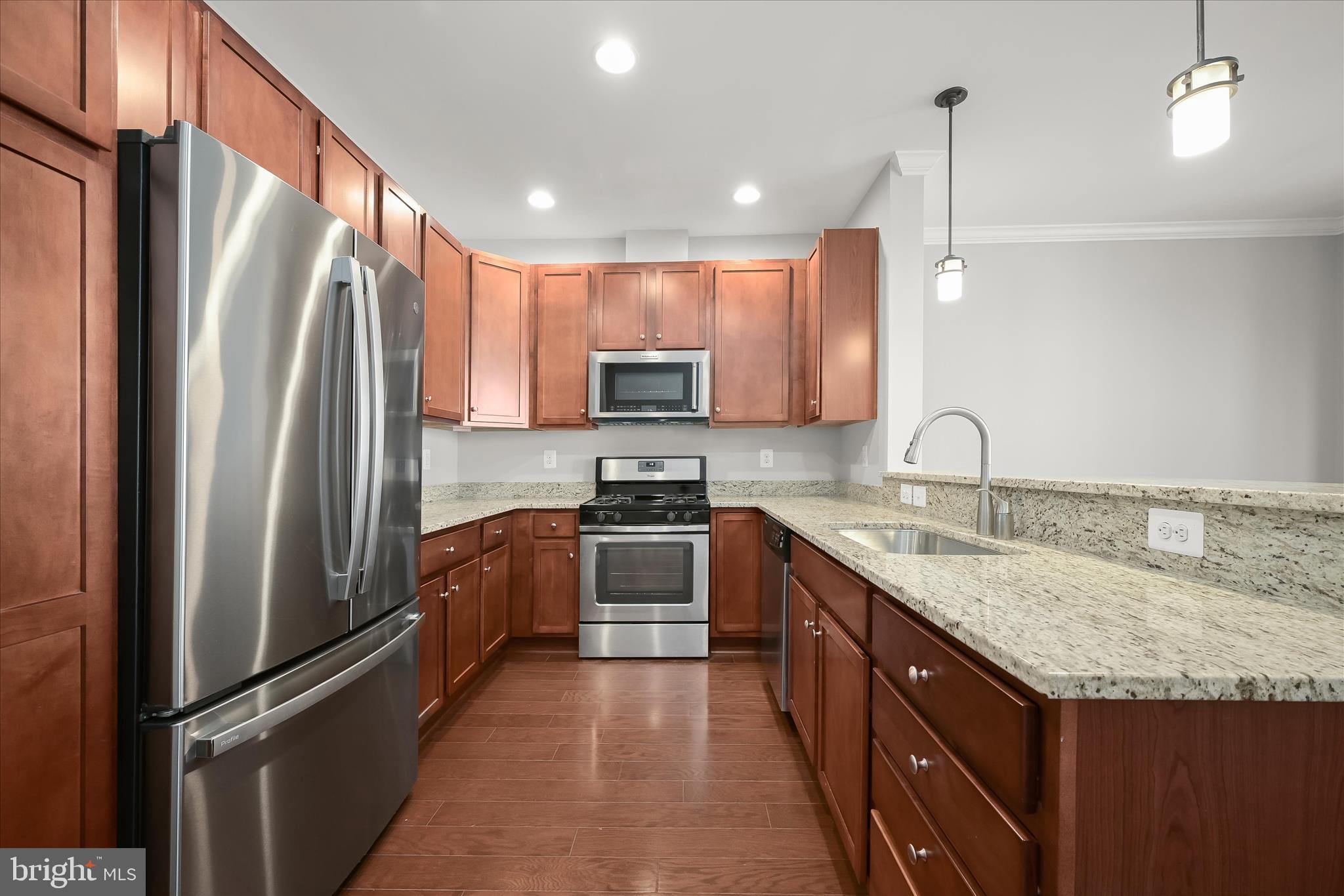 11246-1 Chase Street, Unit 141 Fulton, MD 20759 - Photo 11 of 38 a kitchen with granite countertop a refrigerator and a sink