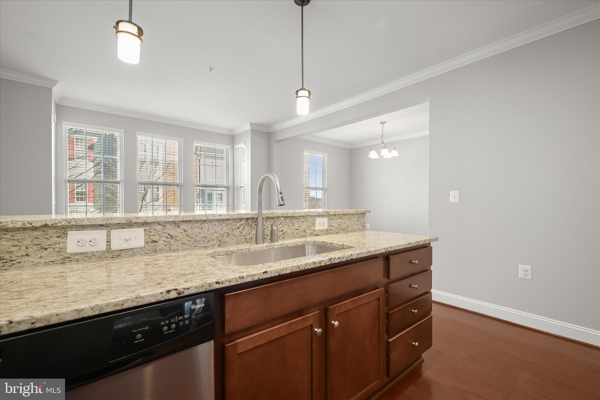 11246-1 Chase Street, Unit 141 Fulton, MD 20759 - Photo 14 of 38 a kitchen with granite countertop kitchen island a sink appliances and a counter top space