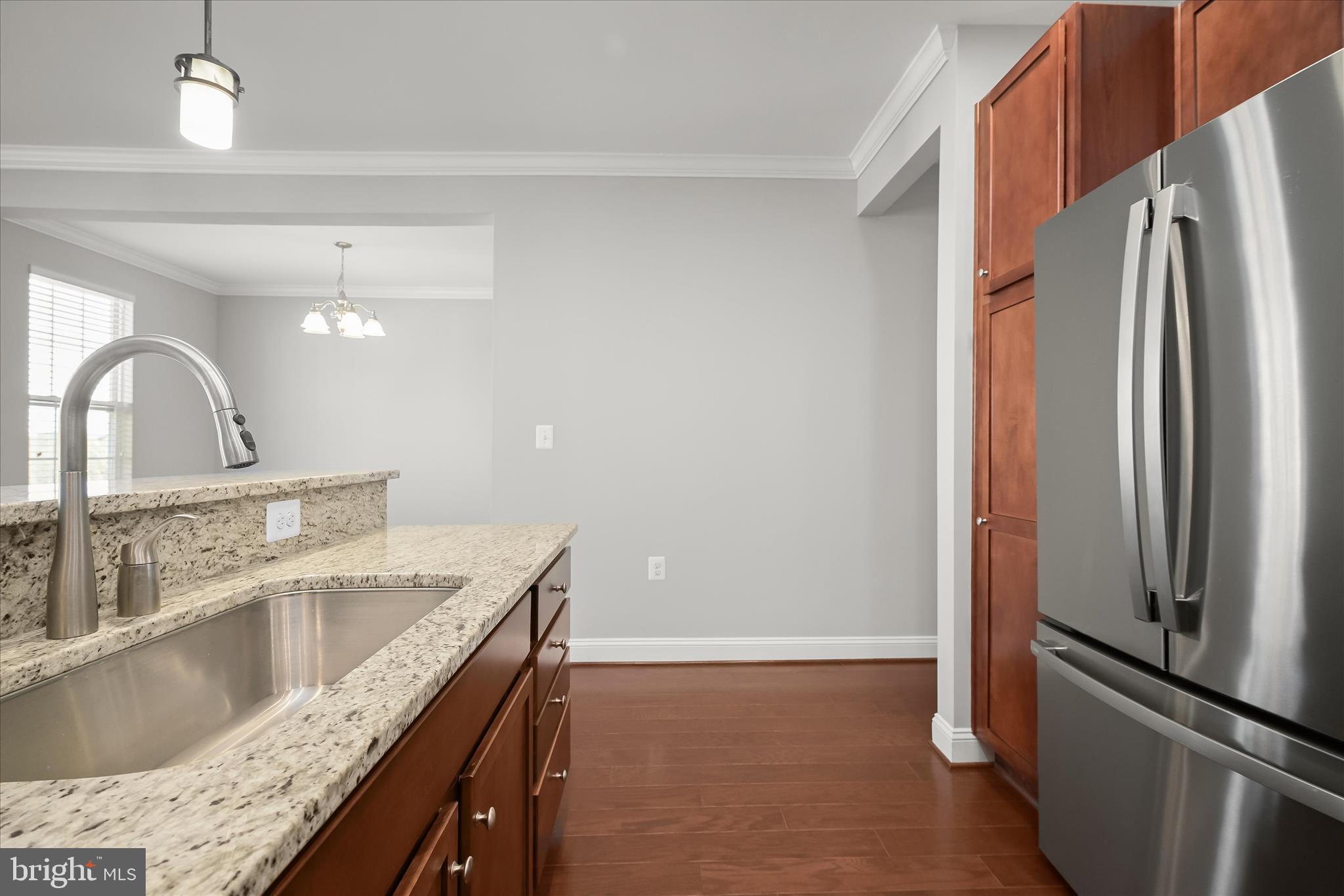 11246-1 Chase Street, Unit 141 Fulton, MD 20759 - Photo 15 of 38 a kitchen with stainless steel appliances granite countertop a refrigerator a sink and a stove