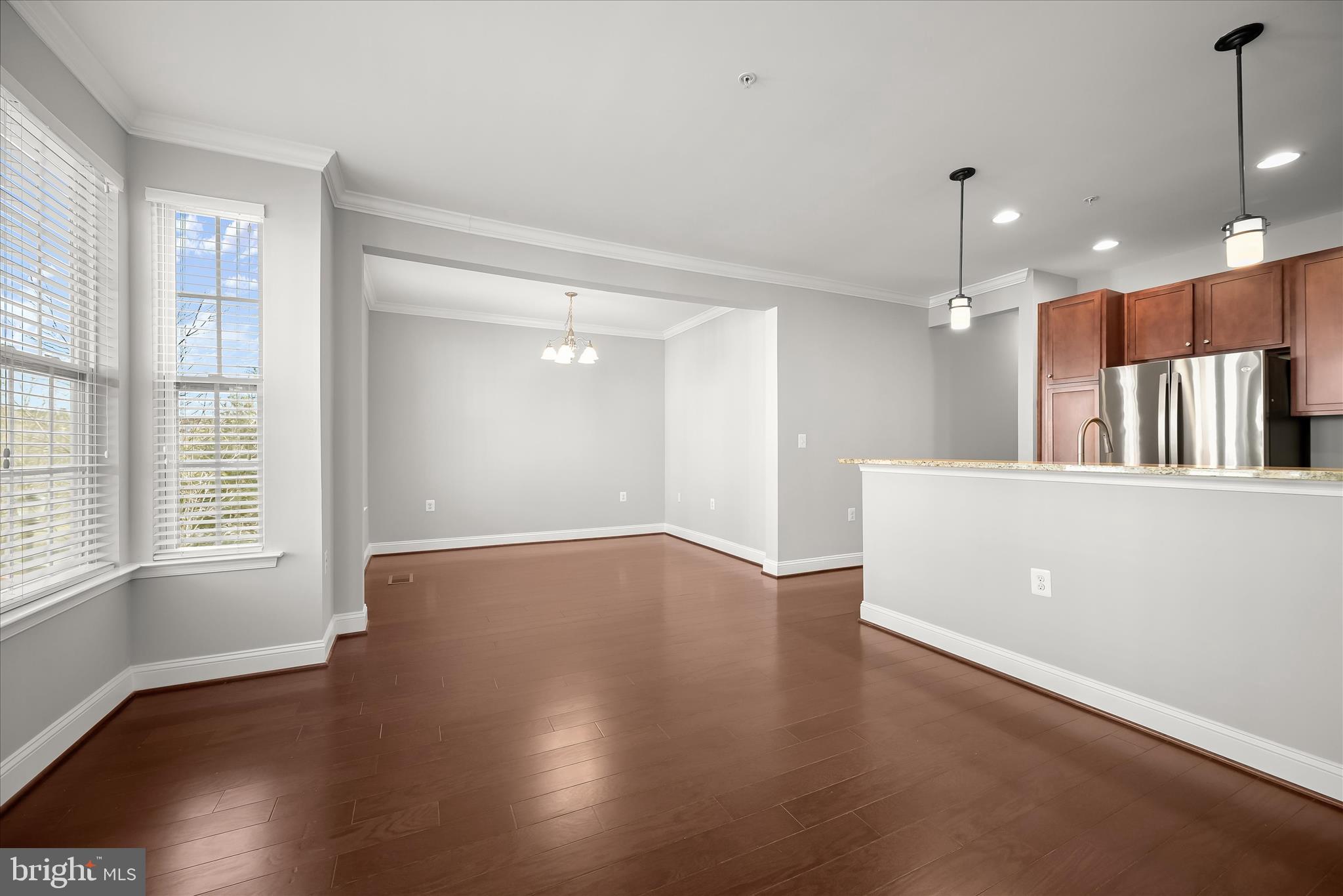 11246-1 Chase Street, Unit 141 Fulton, MD 20759 - Photo 19 of 38 a view of an empty room with wooden floor and a window