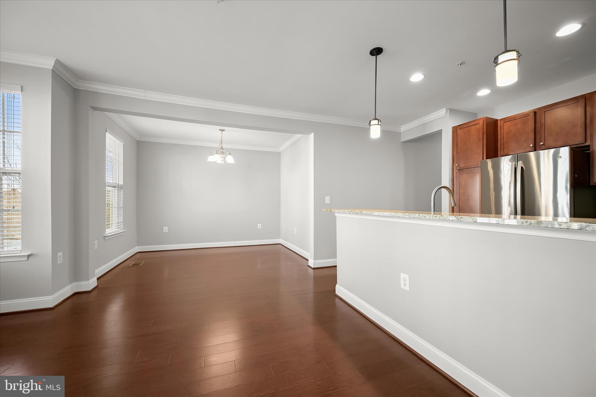11246-1 Chase Street, Unit 141 Fulton, MD 20759 - Photo 21 of 38 a view of a kitchen with a dishwasher and wooden floor