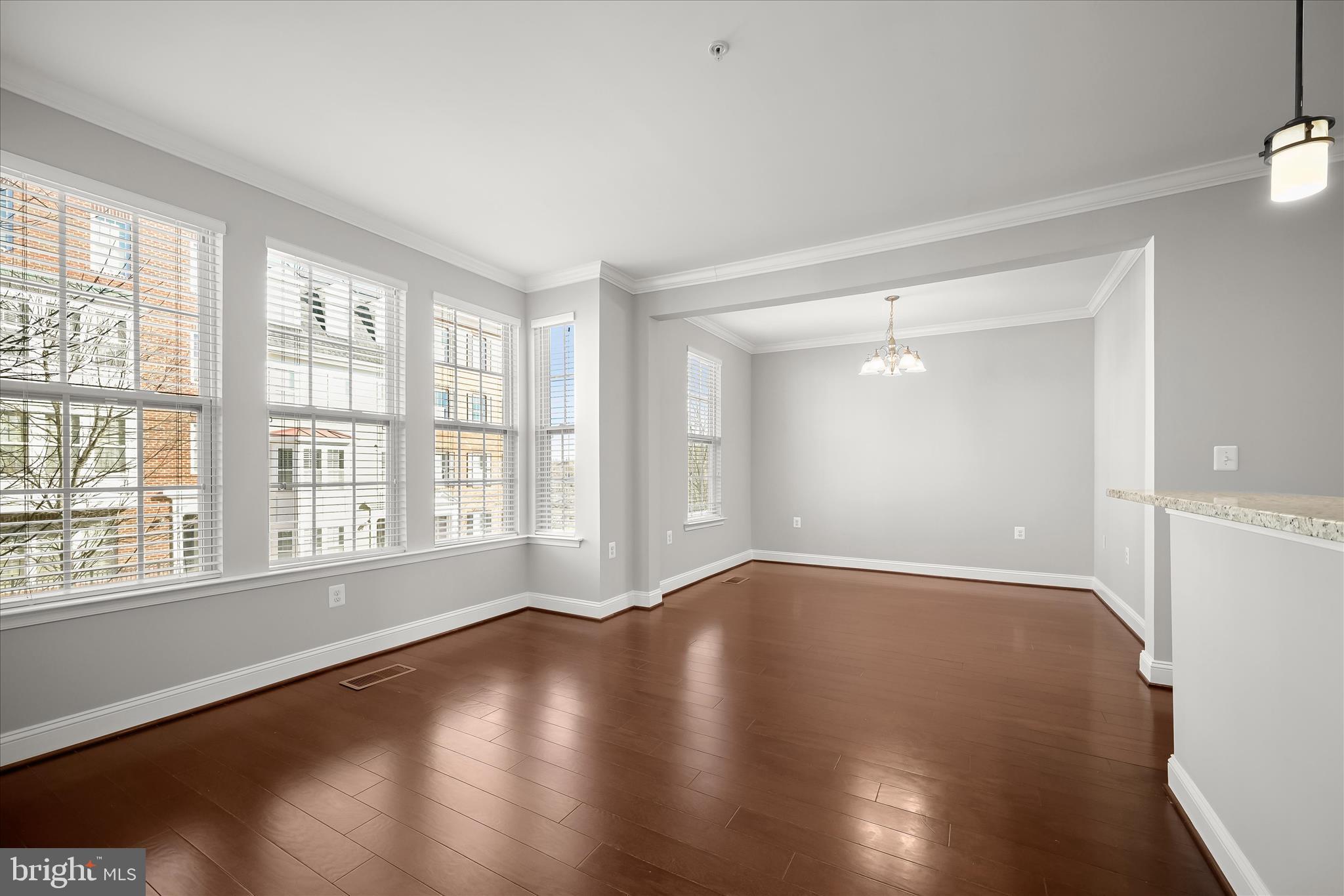 11246-1 Chase Street, Unit 141 Fulton, MD 20759 - Photo 22 of 38 a view of an empty room with wooden floor and a window