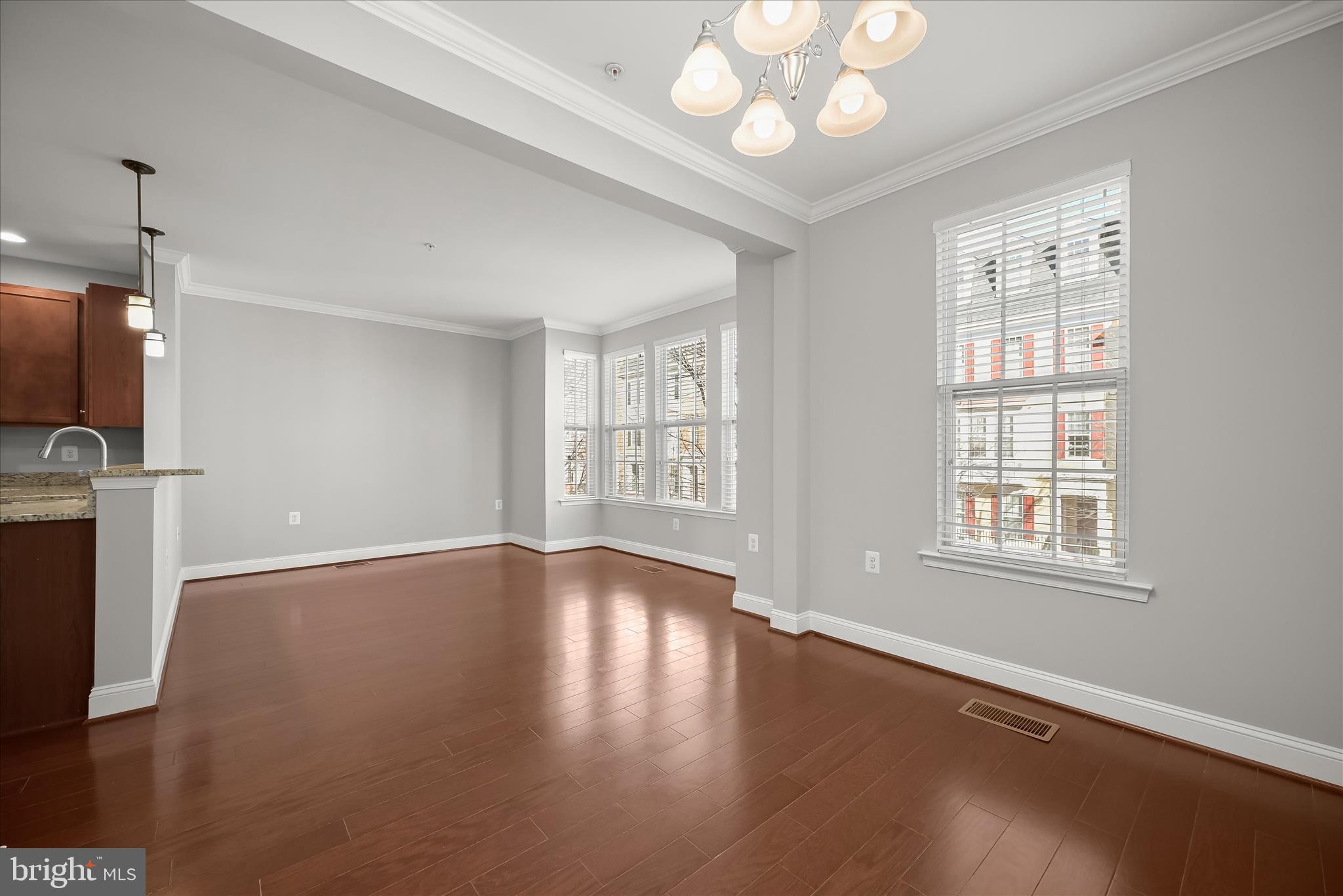 11246-1 Chase Street, Unit 141 Fulton, MD 20759 - Photo 24 of 38 a view of an empty room with wooden floor and a window