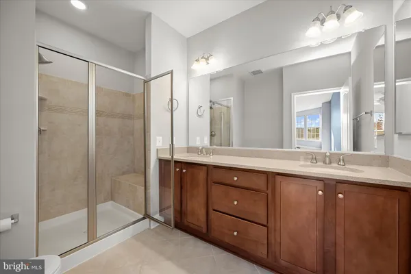 a bathroom with a shower sink and mirror