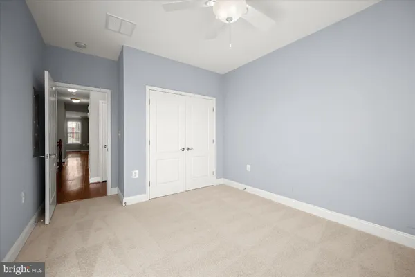 an empty room with chandelier fan