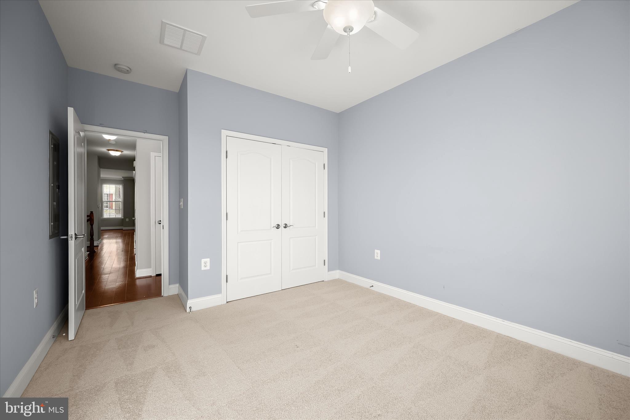 11246-1 Chase Street, Unit 141 Fulton, MD 20759 - Photo 34 of 38 an empty room with chandelier fan