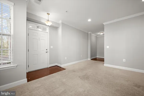 an empty room with windows and entrance