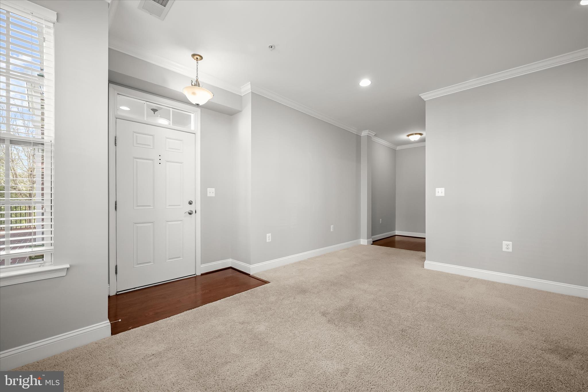 11246-1 Chase Street, Unit 141 Fulton, MD 20759 - Photo 7 of 38 an empty room with windows and entrance