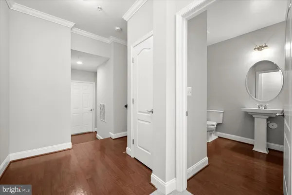 a view of a room with wooden floor and bathroom