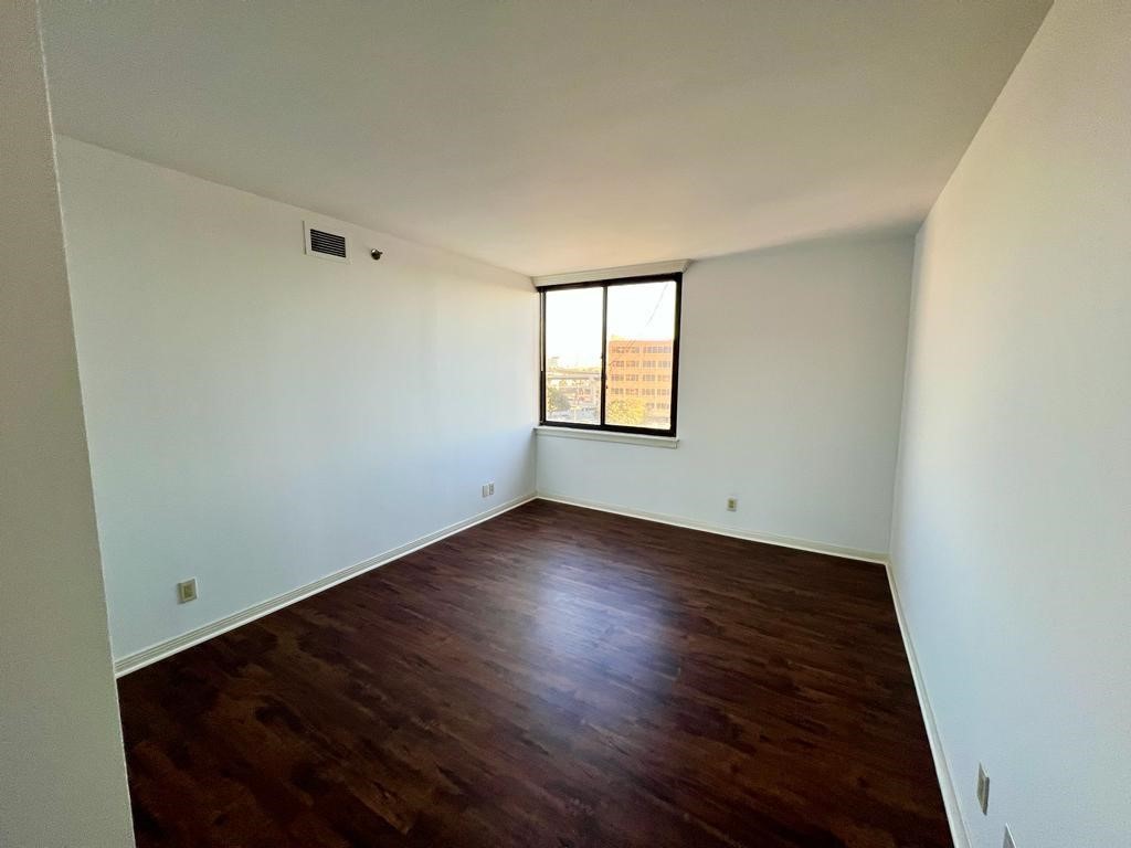 3525 Sage Road, Unit 704 Houston, TX 77056 - Photo 11 of 29 an empty room with wooden floor and windows