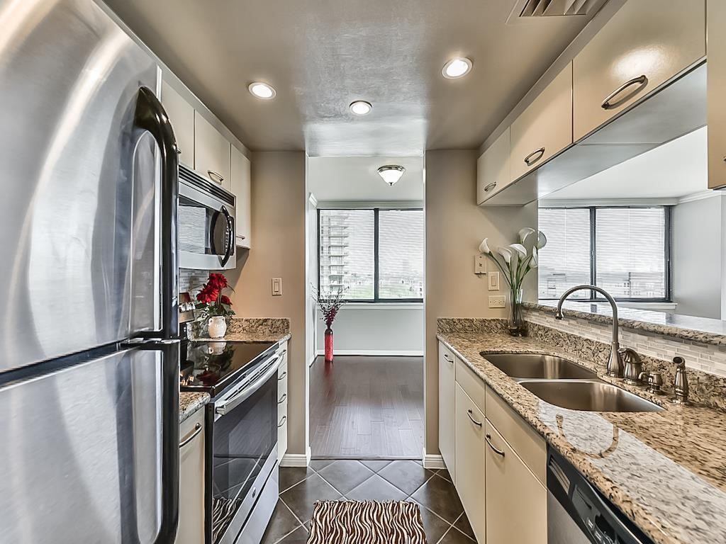 3525 Sage Road, Unit 704 Houston, TX 77056 - Photo 13 of 29 a kitchen with stainless steel appliances granite countertop a sink stove and refrigerator