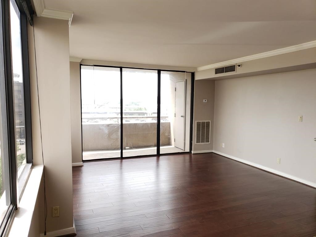 3525 Sage Road, Unit 704 Houston, TX 77056 - Photo 14 of 29 a view of an empty room with wooden floor and a window