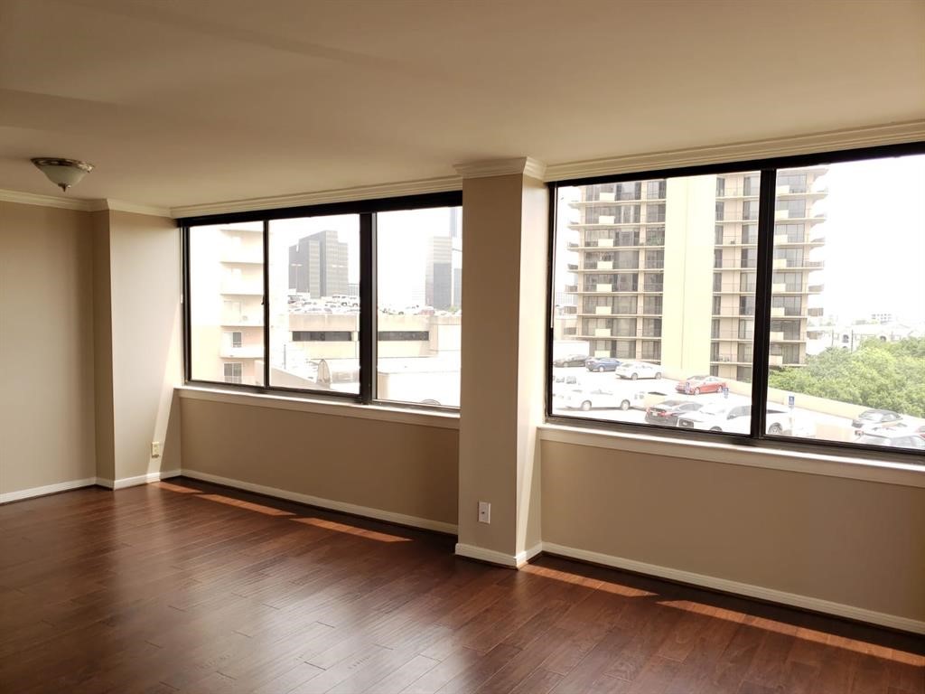 3525 Sage Road, Unit 704 Houston, TX 77056 - Photo 15 of 29 a view of an empty room with wooden floor and a window