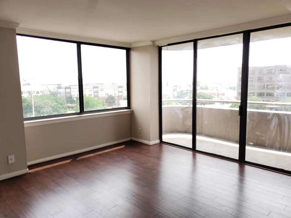 3525 Sage Road, Unit 704 Houston, TX 77056 - Photo 16 of 29 a view of an empty room with wooden floor and a window