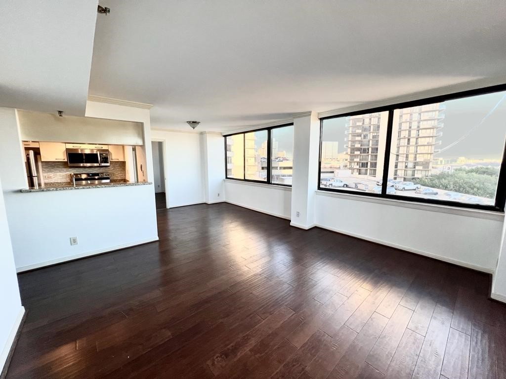 3525 Sage Road, Unit 704 Houston, TX 77056 - Photo 17 of 29 an empty room with wooden floor and windows